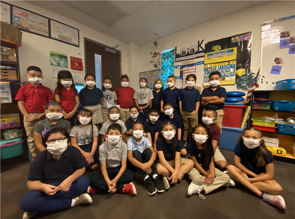 Class photo of students displaying their \